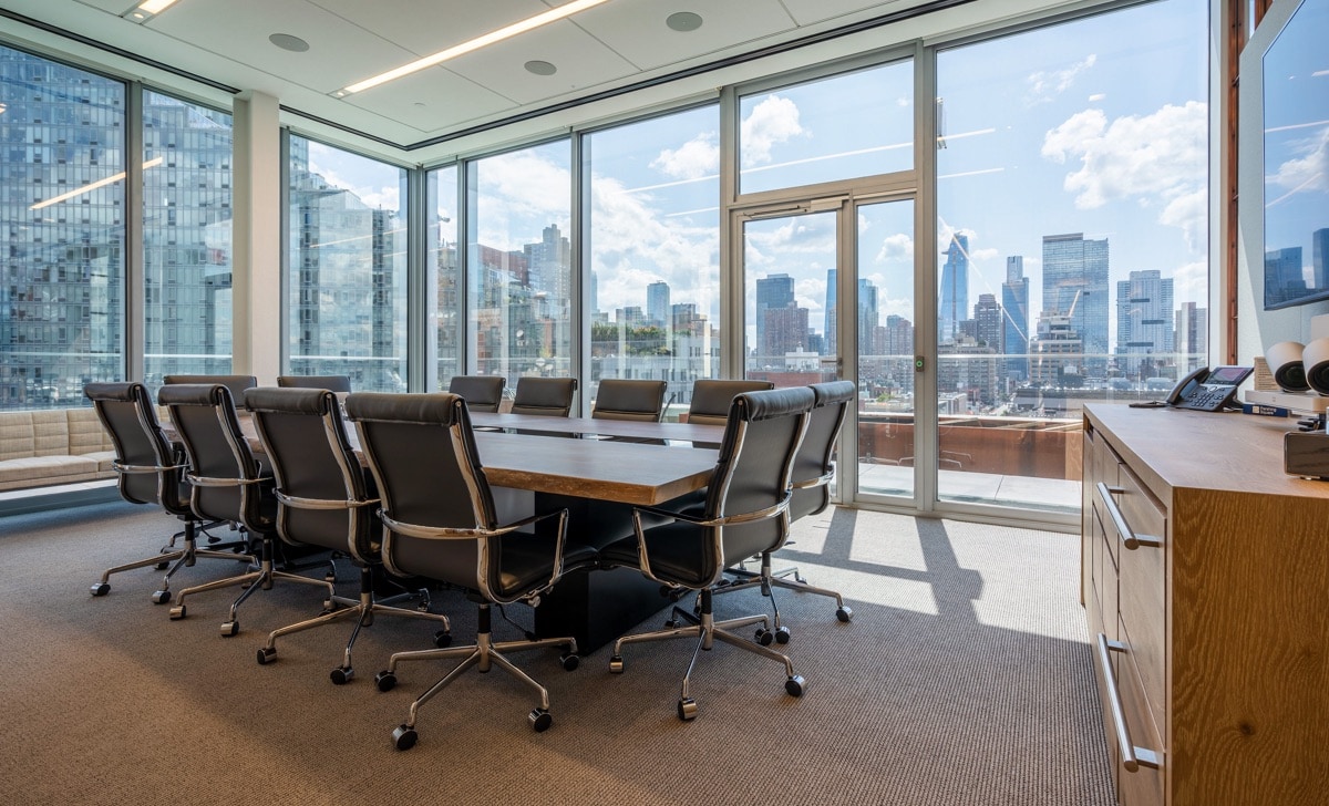 12-person conference room with glass walls overlooking Hell's Kitchen